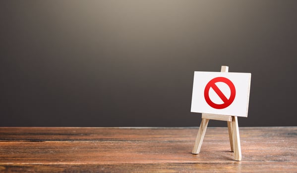 Easel with the prohibition sign NO. Restricted area. Restrictions and sanctions. Inaccessibility. Blocking. Out of stock. Ban and Embargo. Failed strategy. Denying entry, stopping action processes. photo