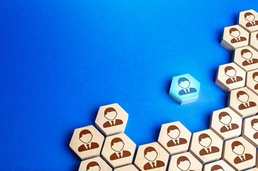 An employee leaves a large group of people. Exit from mainstream society. A talented employee, professional growth, search for a new promising job. Training courses. Change and striving for the best. photo
