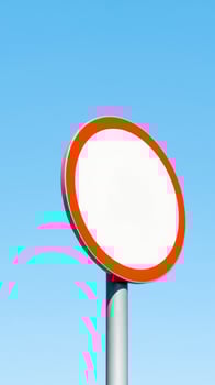 blank circular sign with red border against blue sky photo