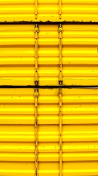 close-up view of vibrant yellow corrugated metal texture photo