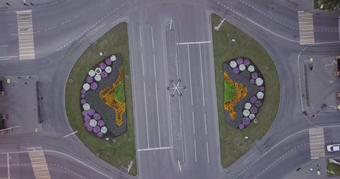 Aerial view of a beautifully designed flowerbed roundabout with various decorative designs. Stock Clip photo