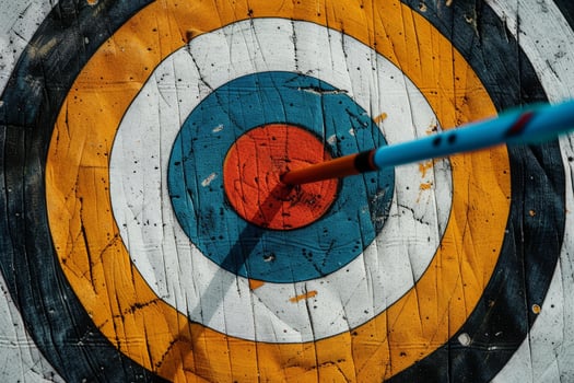 Arrow hitting the center of archery target, achieving goal photo