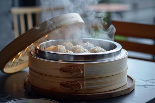 Steaming hot dumplings in a bamboo steamer basket, ready to eat photo