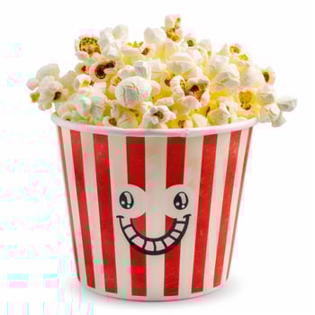 Striped popcorn bucket smiling and overflowing on white background photo