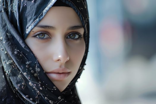 Portrait of young muslim woman wearing hijab looking at camera photo