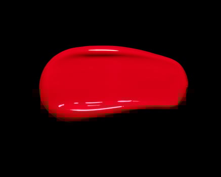 red lipgloss swatch on black background, cosmetic or beauty product texture photo