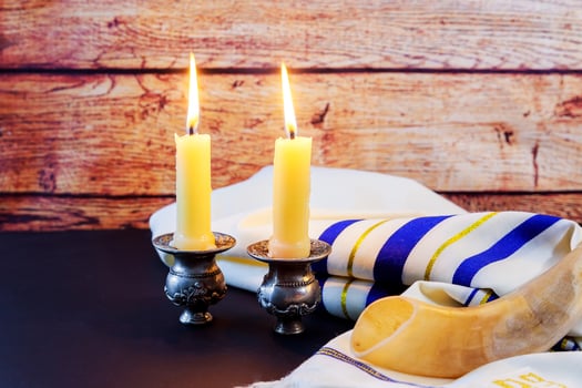 Shabbat candles in glass Jewish holiday Sabbath Prayer Shawl Tallit and Shofar horn jewish religious symbol photo