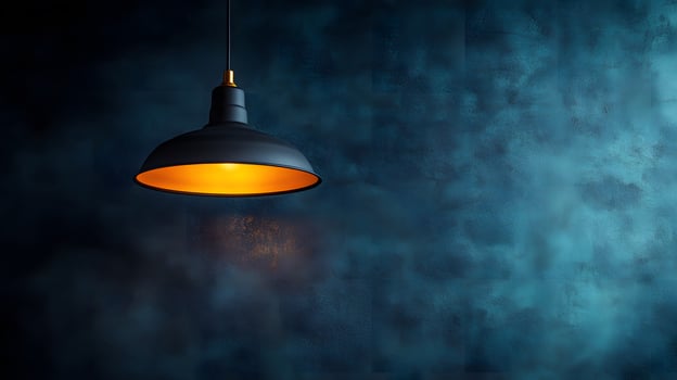 Minimalist pendant lamp creating dramatic spotlight effect against black wall, showcasing industrial design with warm light glow in contemporary interior setting. gradient photo