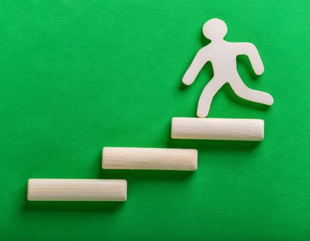 Concept of Success Wooden Figures Ascend a Challenging Slope photo