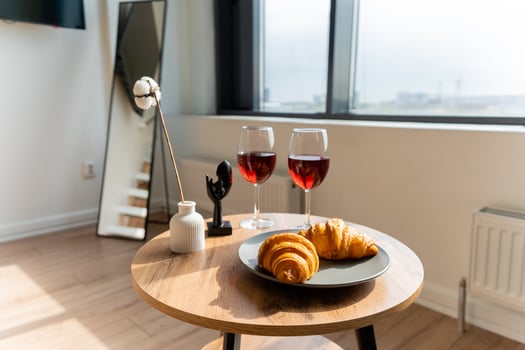 A table with fresh croissants and two elegant wine glasses photo
