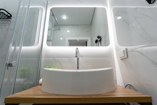Explore a Modern Bathroom Design that features a sleek vessel sink paired with bright, inviting lighting for a fresh and stylish ambiance photo