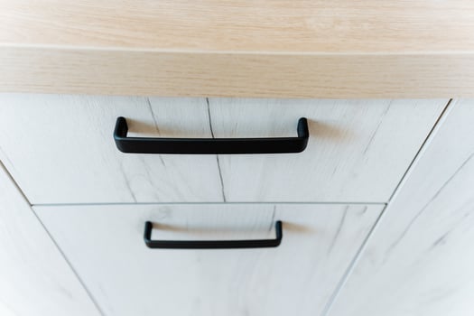 Close up of rectangular wooden cabinet with black handles photo