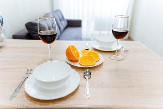Food and drink served on tableware including plates, bowls, and wine glasses photo