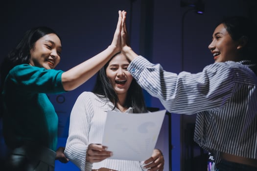 Three women giving high five to each other photo