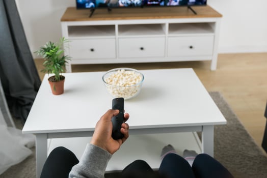 Remote control is pointed toward the television screen, control and choice of tv entertainment. TV, series and streaming service concept photo
