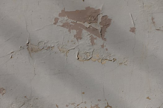Cracked and peeling wall reveals layers of history in urban decay photo