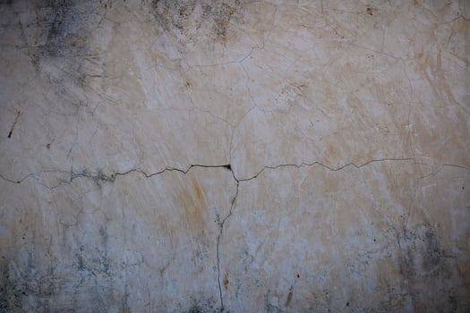 Cracked plaster wall revealing the passage of time in a rustic setting photo