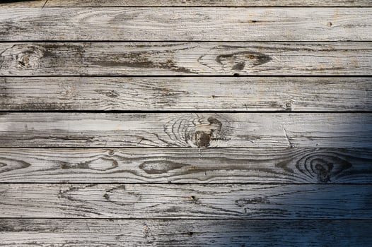Weathered wood planks create a rustic tapestry of texture and character in warm afternoon sunlight photo