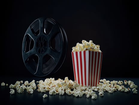 Vintage cinema experience with popcorn and film reel in classic style photo