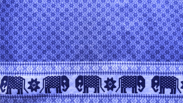 A blue and white striped fabric with elephants on it.38 photo