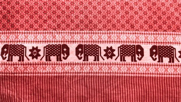 A red and black striped cloth with elephants on it photo