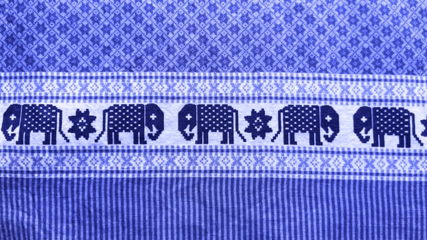 A blue and white striped cloth with elephants on it.35 photo