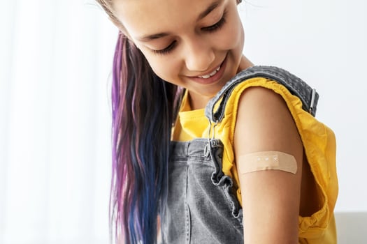 Healthcare And Inoculation Concept. Portrait Of Smiling Teen Patient Showing Vaccinated Arm With Plaster On Shoulder After Coronavirus Vaccination, Looking At Hand. Antiviral Vaccine, Banner, Panorama photo