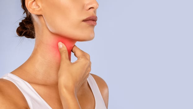 Healthcare, Cold and People Concept. Closeup of unrecognizable sick woman suffering from sore throat, ill lady touching neck with hand, inflamed red zone, banner, panorama, free copy space photo
