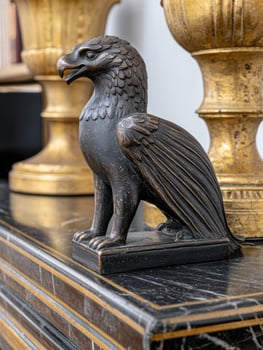 Bronze eagle statue on dark marble surface photo