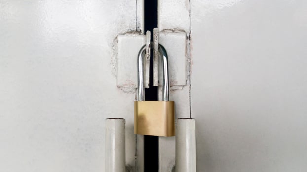 Gray metal door with Thick metal padlock on. photo