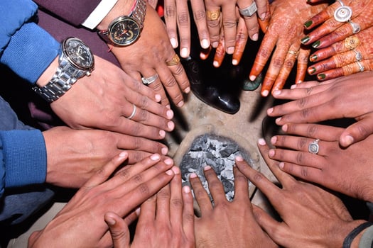 A group of people holding hands in a circle photo