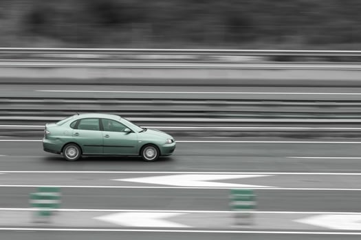 passenger green car on the highway in motion with a blurred background photo