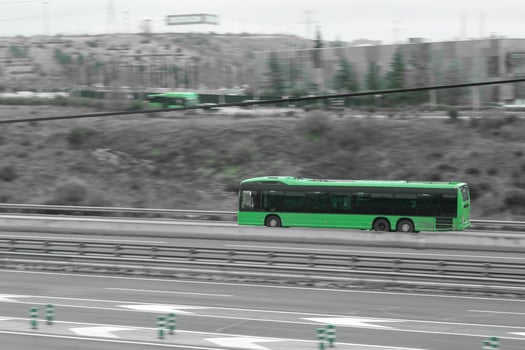 green, passenger car on the highway in motion photo