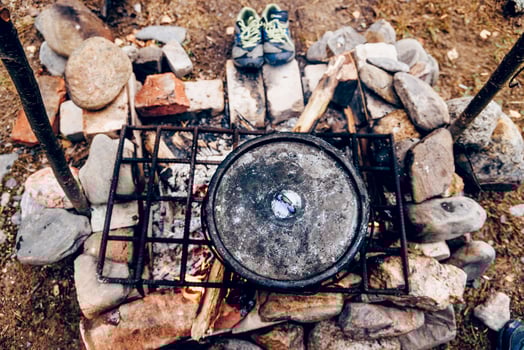 Camping Kitchen, Traveler nature Camp Cooking Food in Pots Campfire, tourist eat soup photo