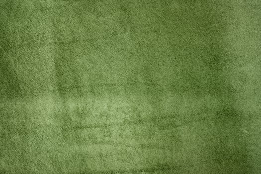 Natural green suede leather as a background macro photo. Suede texture photo