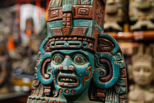 Mayan statue depicting god with intense expression in souvenir shop photo