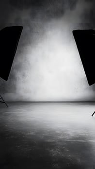 Photo studio with black backdrop and two black lights