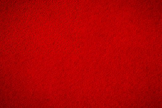 Red suede with darkening along the edge. Suede macro as a background. photo