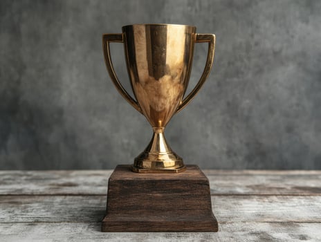Gold trophy on wooden base photo