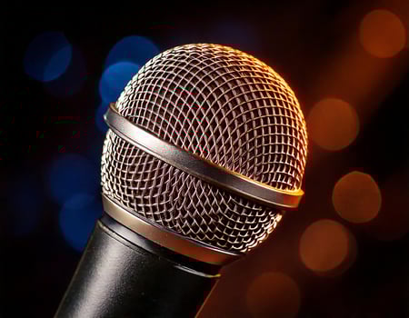 A microphone seen up close with a bokeh background. photo