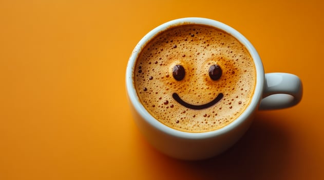 A smiling coffee cup with a smiley face drawn on it. The cup is white and filled with coffee photo