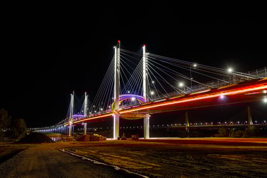 Neon Symphony A Nighttime Dance of Light Trails Beneath the Majestic Cable-Stayed Bridge photo