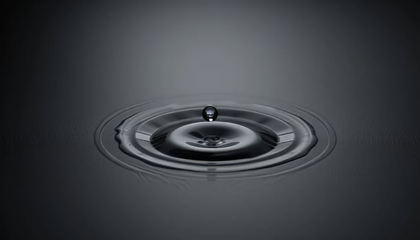 A Single Drop of Water Creates a Stunning Ripple Effect on a Dark Surface, Capturing the Essence of Tranquility and Minimalism in a Captivating Still Life Photograph photo