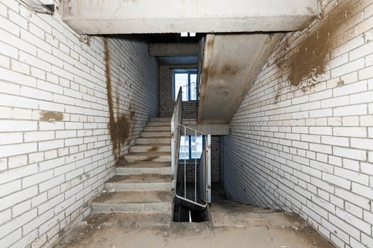 Forgotten Passage A Rugged Stairwell in White Brick and Concrete, Echoing Stories of Urban Decay and Untold Journeys. photo