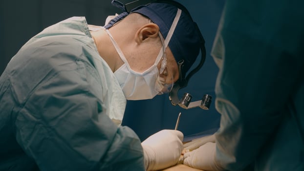 Doctor man in uniform physician surgeon medic nurse performing surgical operation at hospital clinic plastic surgery microsurgery saving life patient health emergency medical help medicine healthcare photo