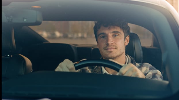 Happy Caucasian man car driver steering wheel enjoy travel trip drive modern electric automobile in city luxurious auto driving handsome guy smile inside suv crossover rent buy vehicle road adventure photo