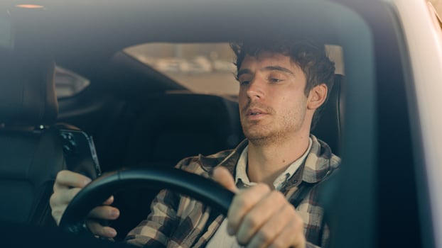 Sad Caucasian man auto driver inside car on parking lot displeased frustrated male businessman using mobile phone read bad news smartphone message upset anxious stressed guy driving travel in city photo