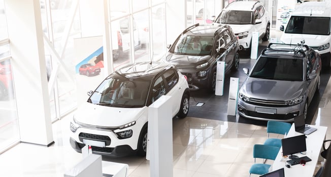 Top view of various newest modern sports, family, medium, multi purpose cars different colours and features at huge luxury dealership salon. Automobiles for sale, auto showroom, copy space photo