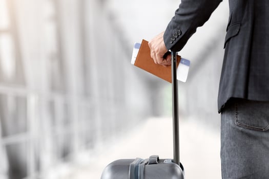 Air Travels Concept. Closeup Shot Of Man With Suitcase Holding Passport And Airline Tickets, Unrecognizable Male Traveller Waiting For Flight Boarding In Arport Terminal, Rear View, Cropped Image photo
