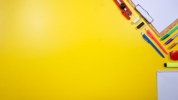School Supplies Isolated on Yellow Background with Copy Space photo